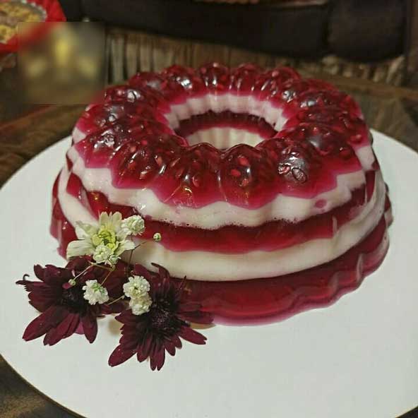 کیک ژله ای سفید قرمز تزیین شده با گل های زیبا برای شب چله